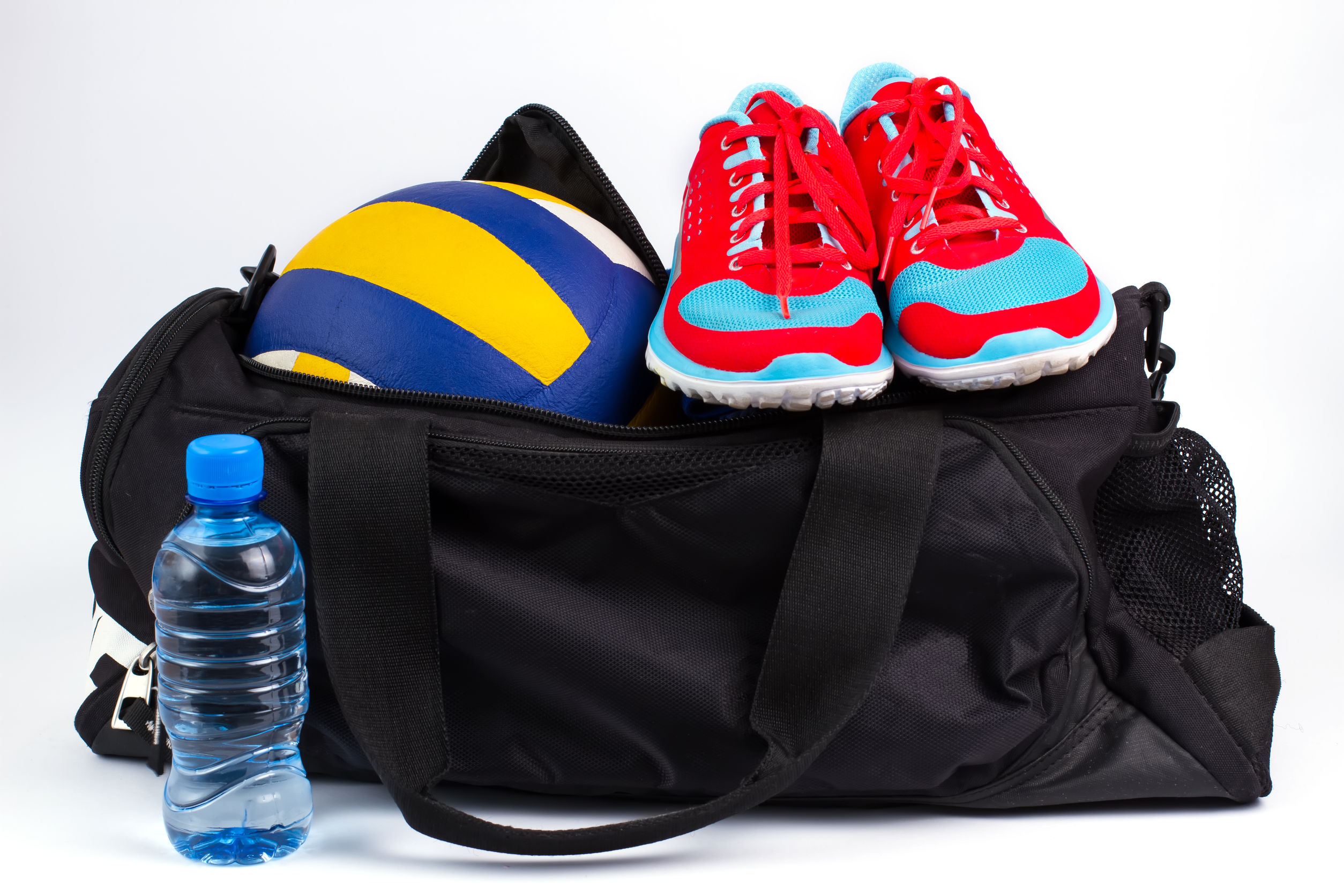 67485769 - sports bag with women's sportswear and volleyball ball.